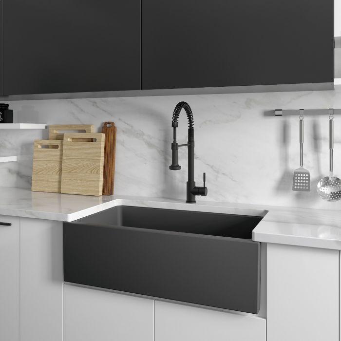Charcoal apron front kitchen sink installed with high-arc faucet and drain