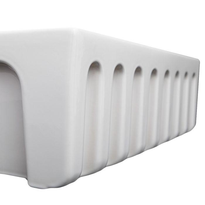White fireclay single-bowl sink underside with apron front detail