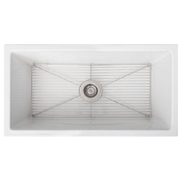 White rectangular sink basin with stainless drain strainer and bottom rack