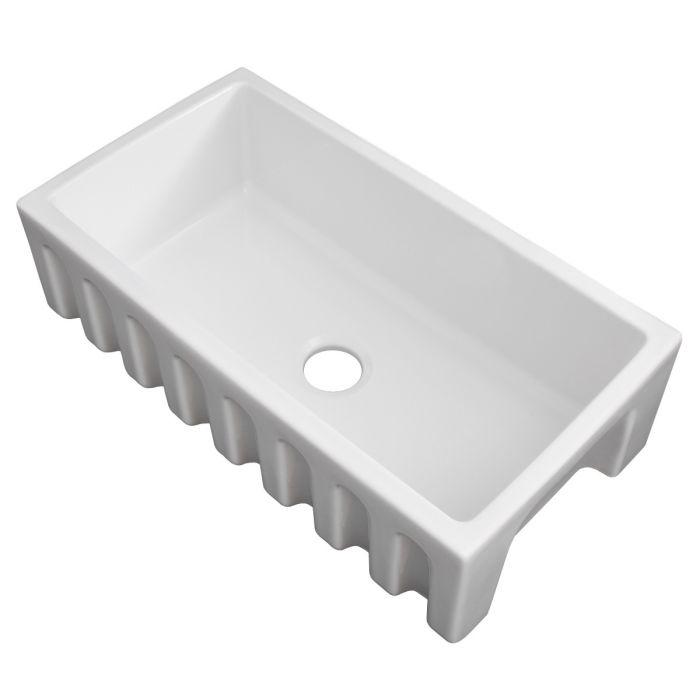 White apron-front single-bowl kitchen sink with drain hole on smooth basin