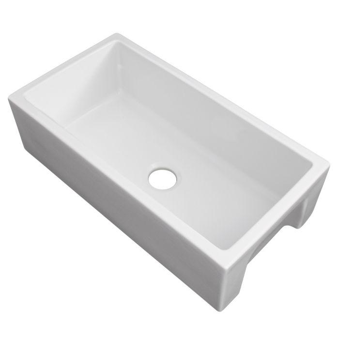 White apron-front single-bowl kitchen sink with flat basin and drain hole