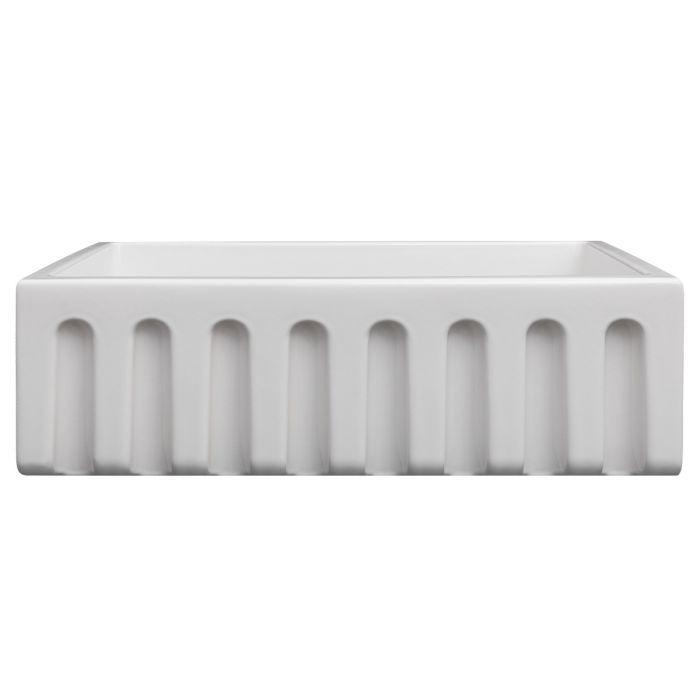 White apron-front single-bowl kitchen sink with ribbed front skirt detail