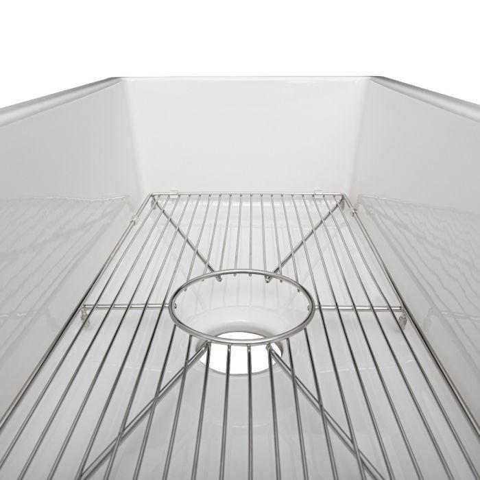 Inside view of white single-bowl sink with bottom rack and drain