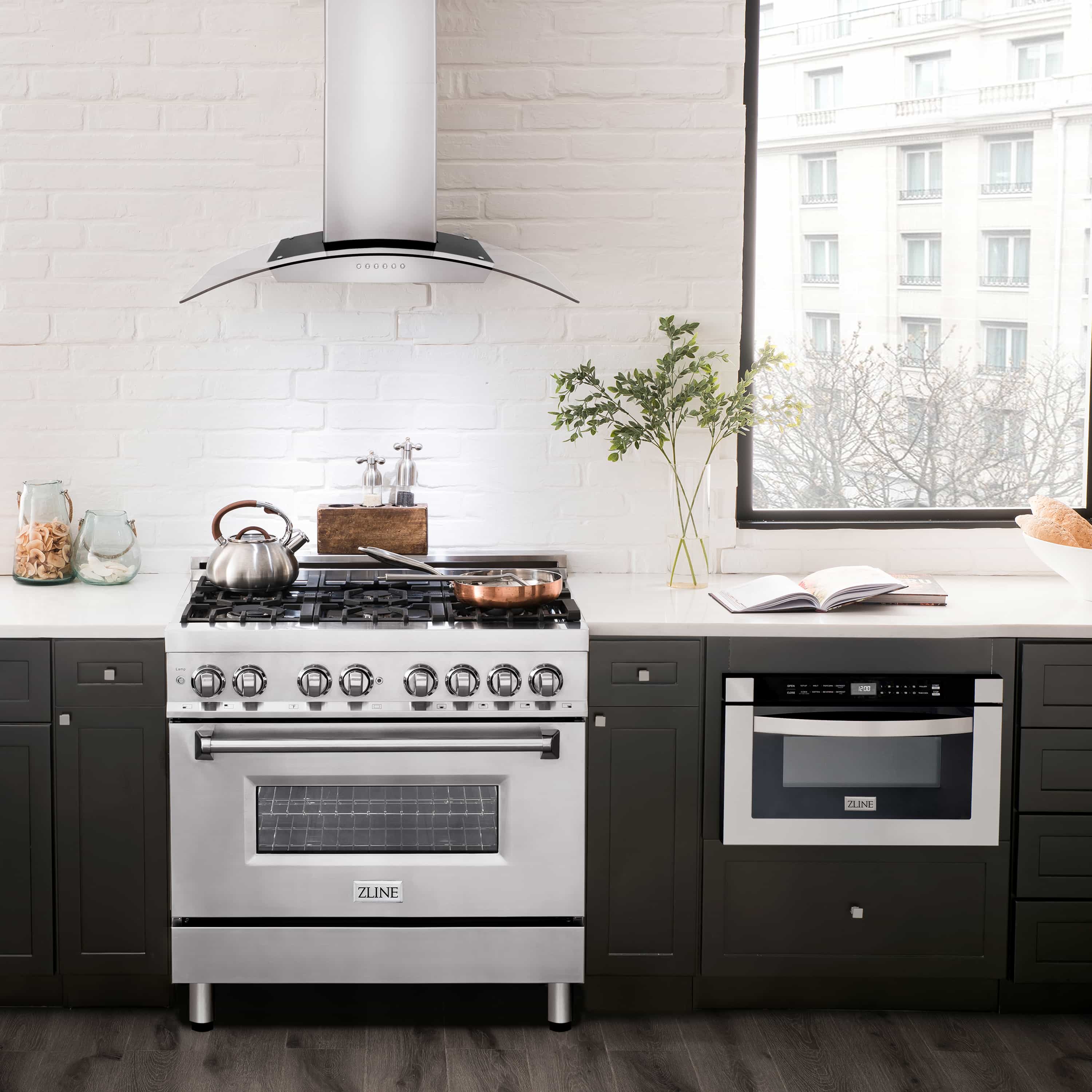Stainless steel wall mount range hood over stove with chimney flue and curved canopy