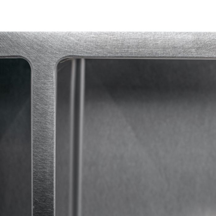 Stainless steel sink corner with smooth rim and inner basin wall detail