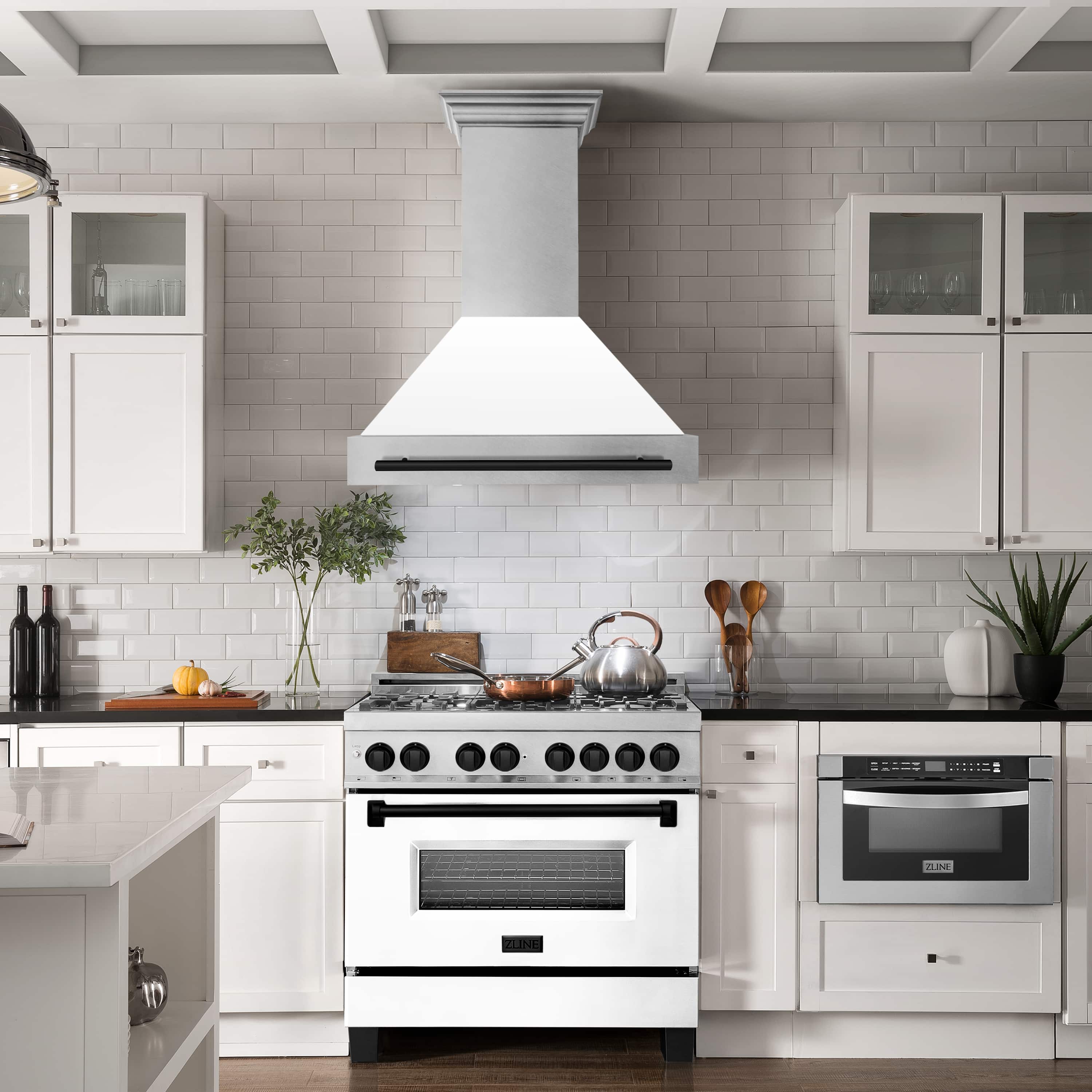 Wall mount range hood centered over cooktop, satin chimney with matte black handle