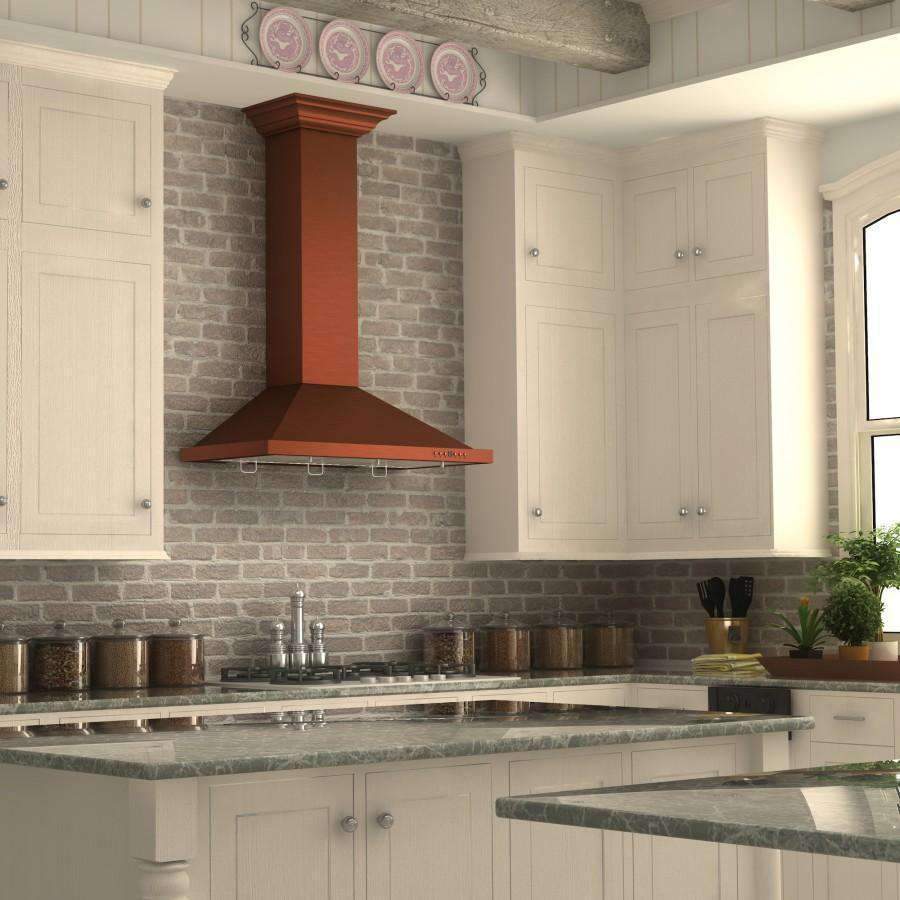 Copper wall range hood with flared chimney column and vented underside.