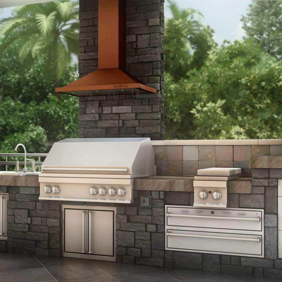 Copper range hood with angled canopy and chimney column over outdoor cooking area.