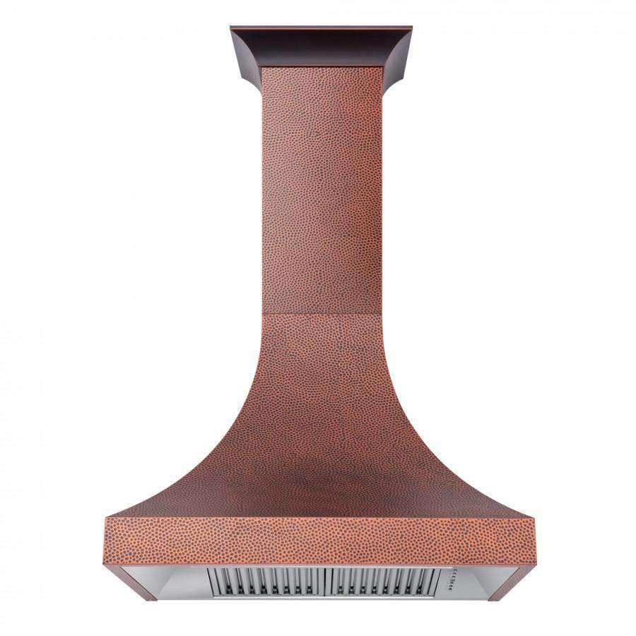 Hand-hammered copper wall range hood with rectangular vent slots and chimney body