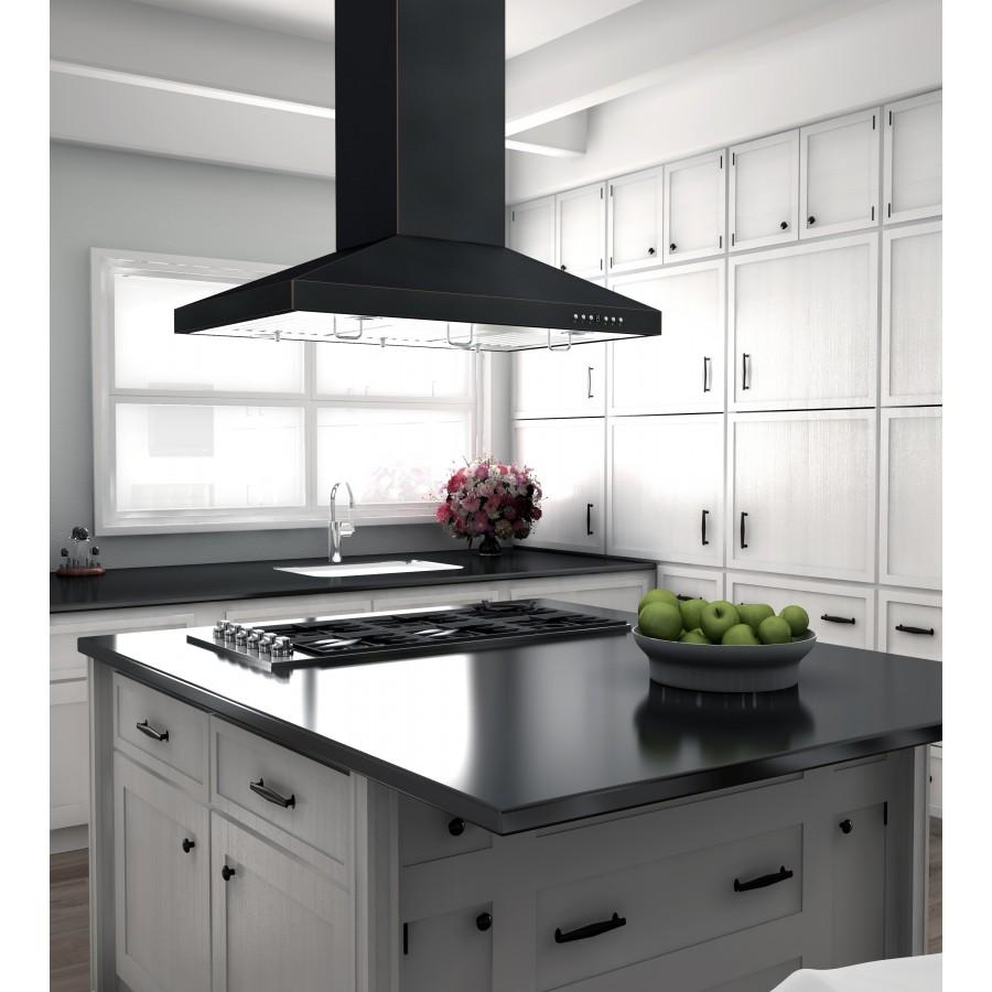 Black island range hood over a cooktop in a bright kitchen with white cabinetry