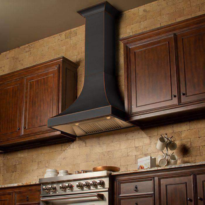 Wall range hood above cooktop with dark chimney and bronze-trim edge, vent visible.