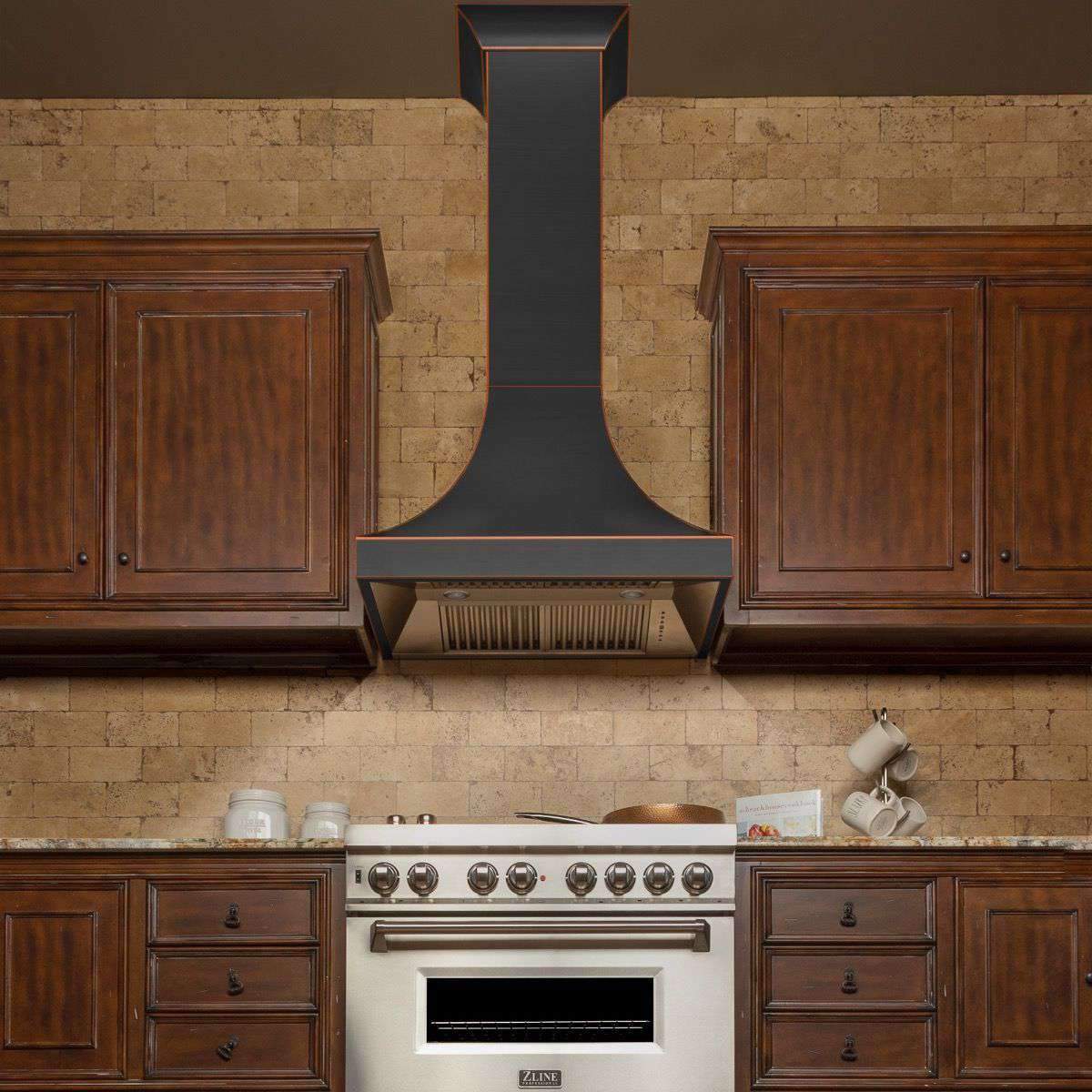 Wall-mount range hood with dark chimney and bronze-trim border above stainless vent.