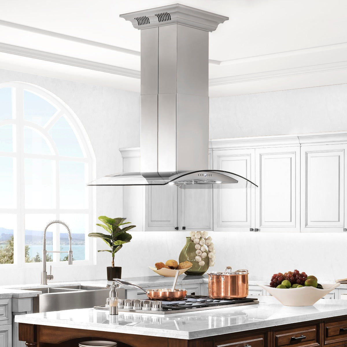 Stainless steel island mount range hood centered over a kitchen cooktop