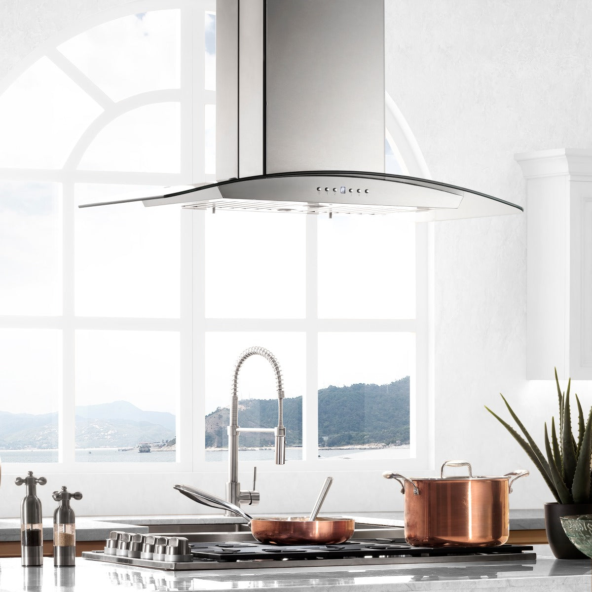 Stainless steel island mount range hood with curved vent canopy and tall chimney