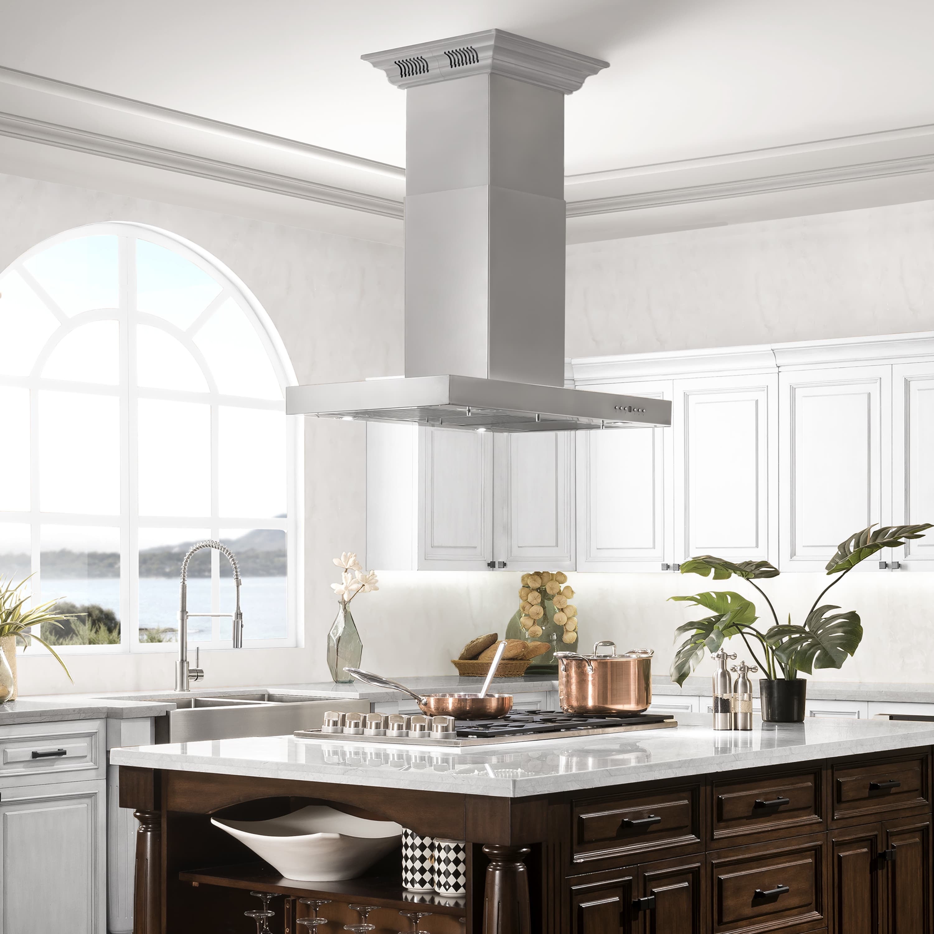 Island mount range hood over kitchen counter, light gray chimney and metal canopy