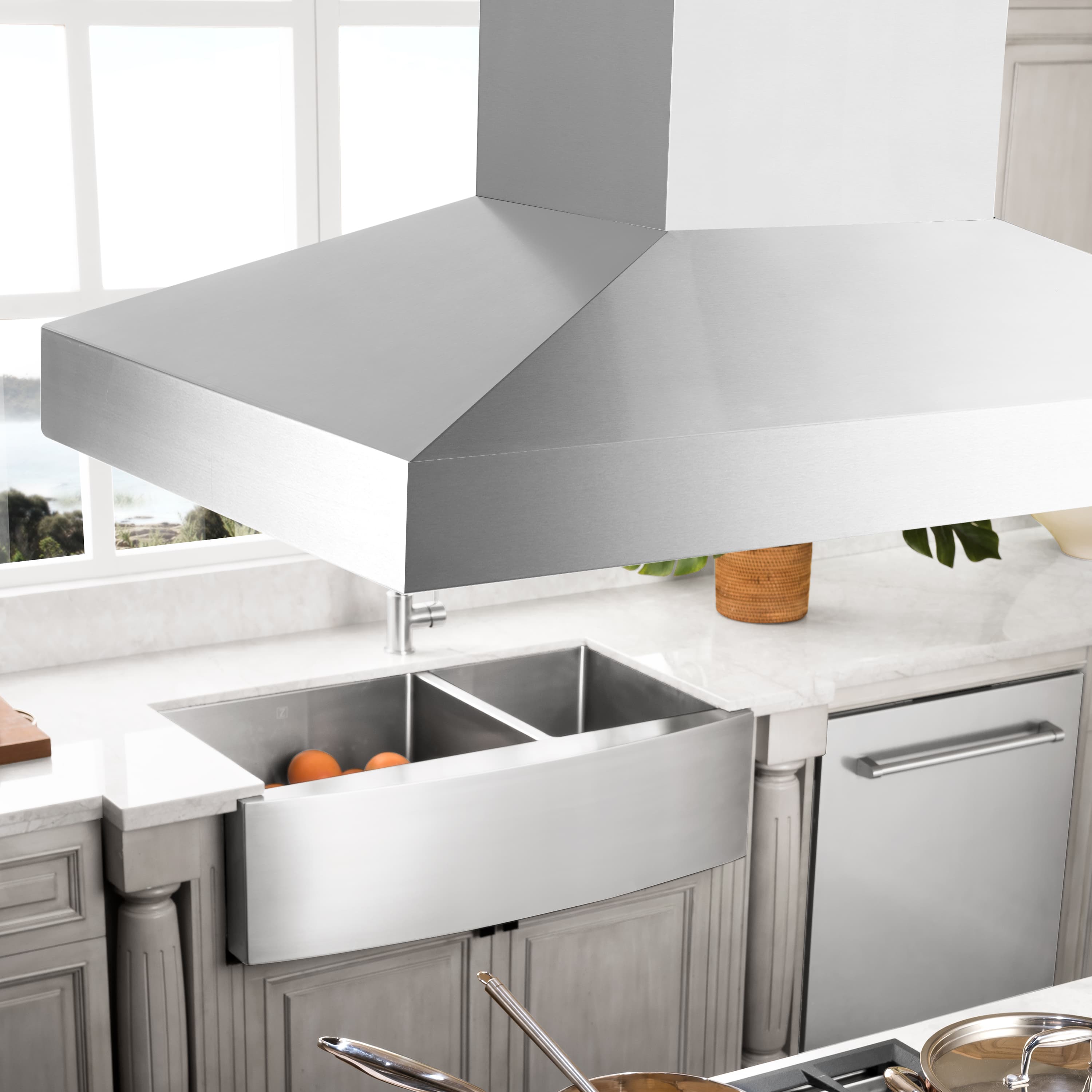 Stainless steel ducted range hood chimney above cooktop with pot filler