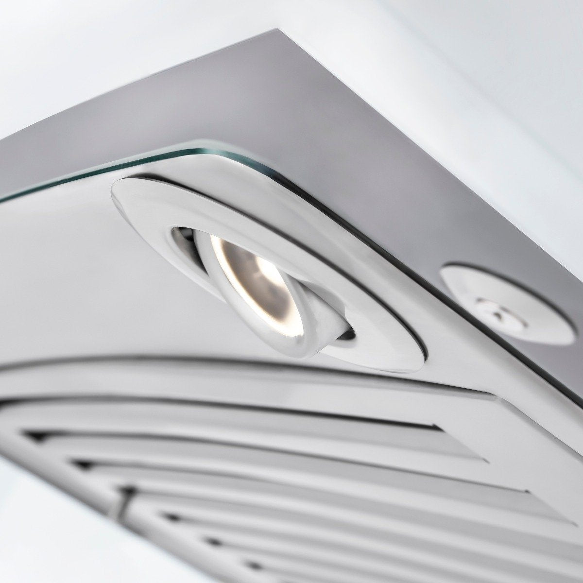 Stainless steel convertible range hood underside with circular vent openings and controls