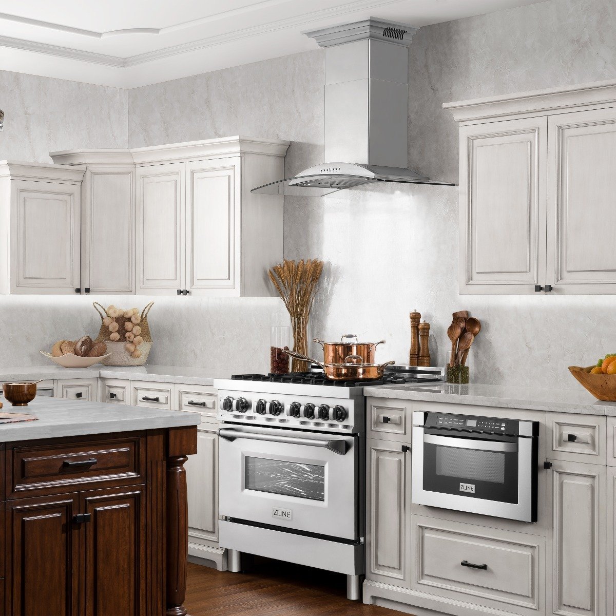 Stainless steel wall mount range hood above a gas range in a kitchen