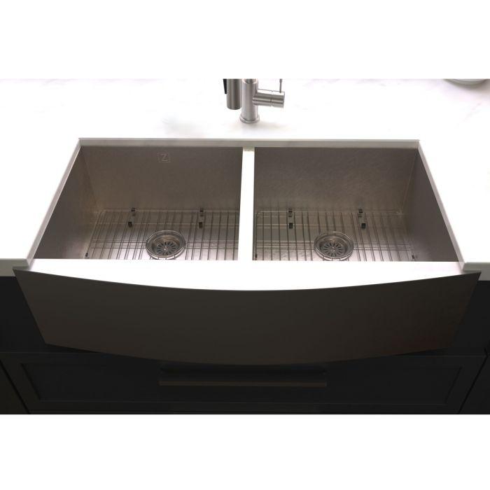 Stainless steel double-bowl sink underside view with two circular drain strainers