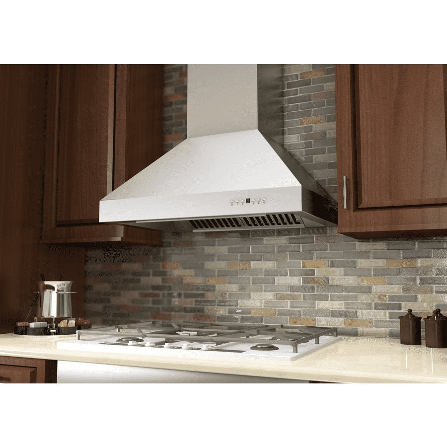 White wall-mounted range hood with vent grille and control buttons above cooktop.