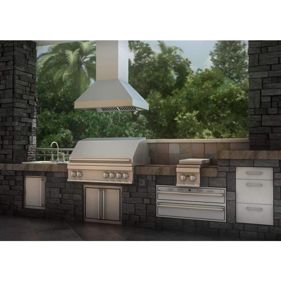 Stainless steel island range hood mounted above an outdoor grill setup