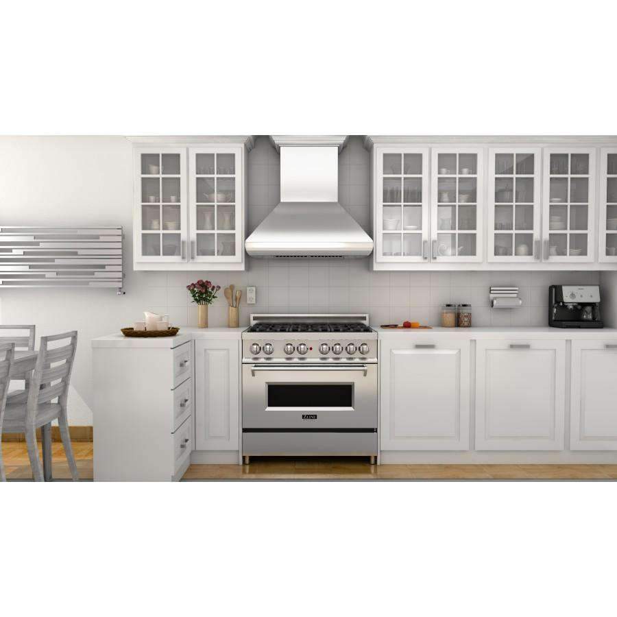 Stainless steel range hood above gas range, chimney-style vent canopy