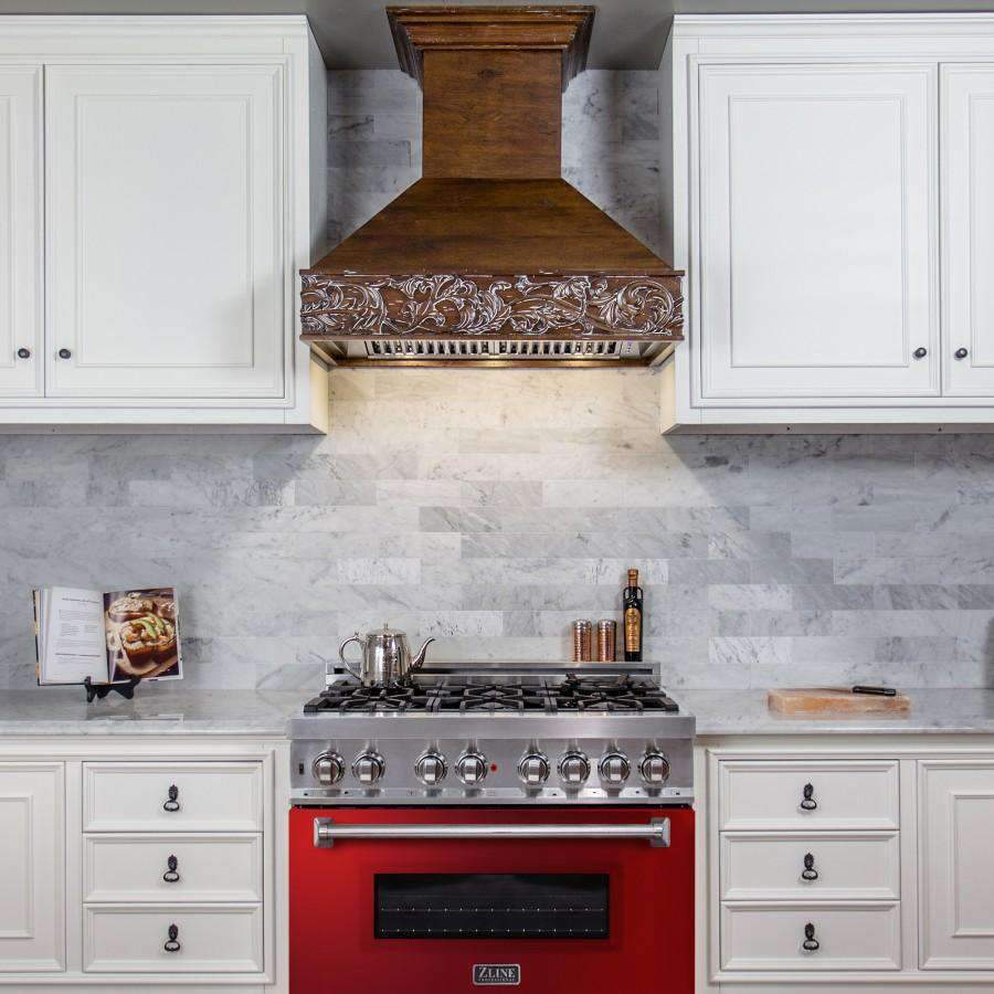 Stainless dual fuel range with red-gloss oven door in a white kitchen setting
