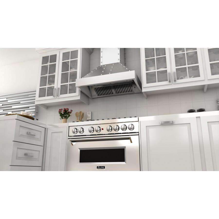 Stainless steel wall range hood with vent fan grille above stove in white kitchen