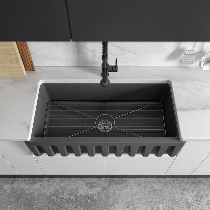 Charcoal farmhouse sink with bottom grid and black gooseneck faucet