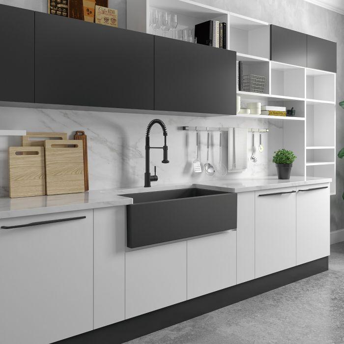 Charcoal single-bowl sink in kitchen with apron front and visible drain area