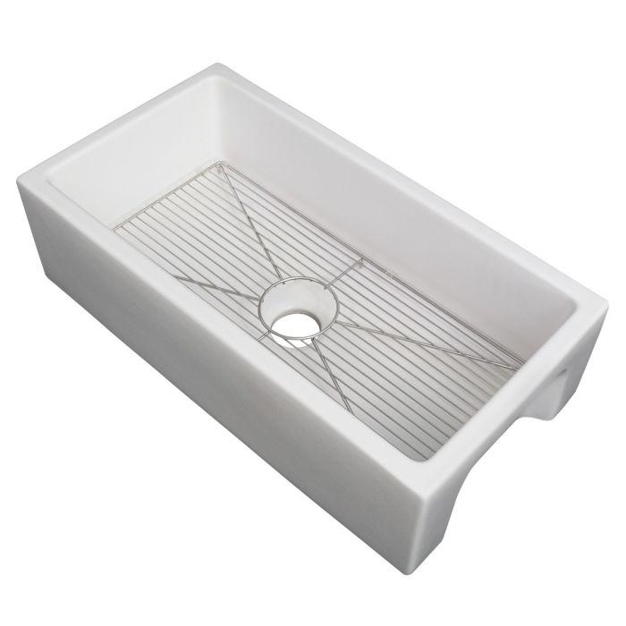 White rectangular fireclay single-bowl sink with stainless bottom grid and drain hole