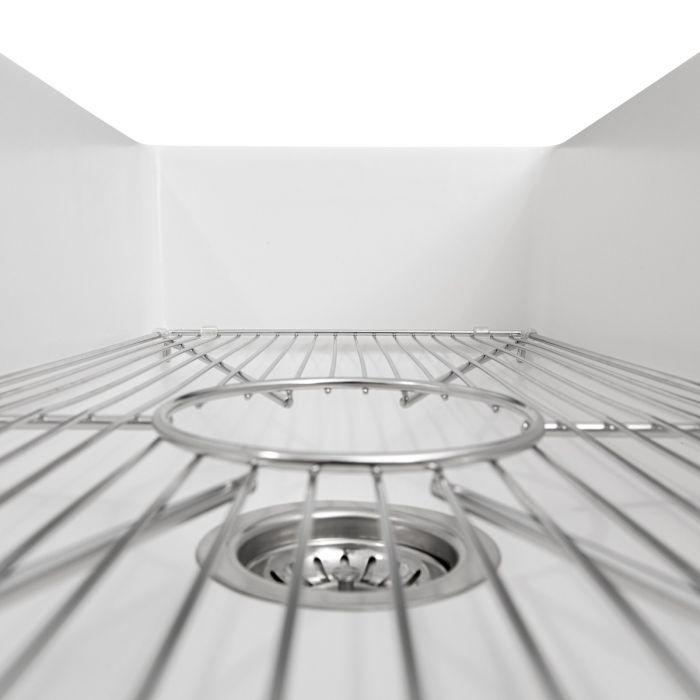 White fireclay kitchen sink bottom with stainless bottom grid and circular drain
