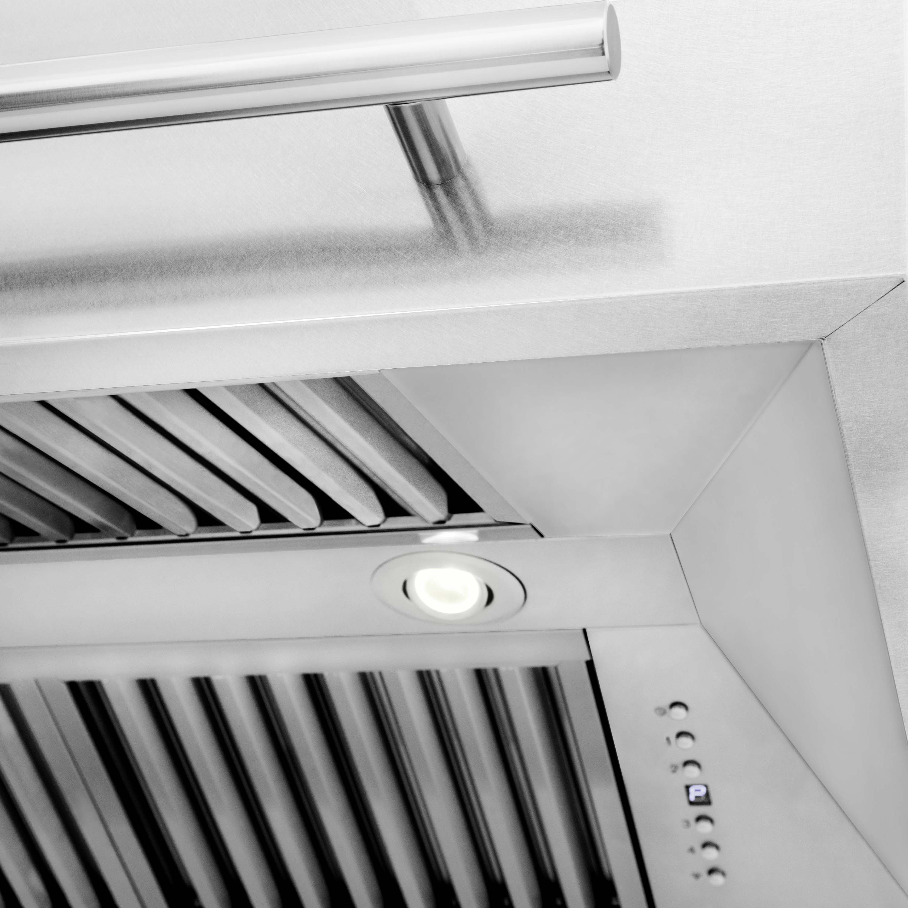 Wall mount range hood with satin stainless baffle filters, round light, and buttons