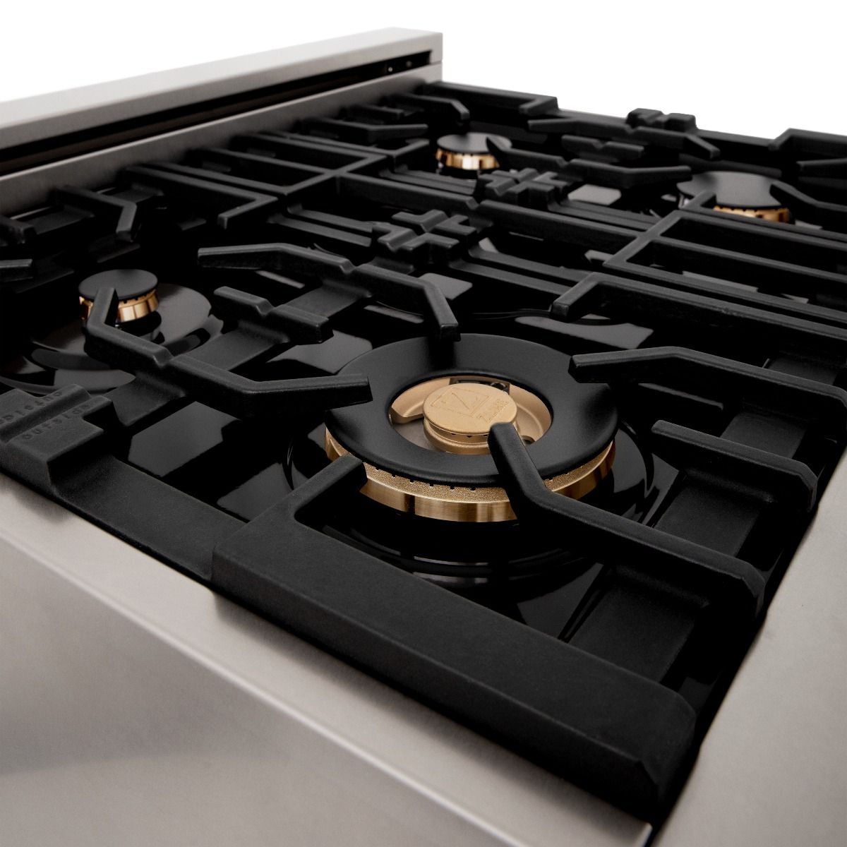 Black gas cooktop with brass burner caps and black cast grates, close-up on front burner
