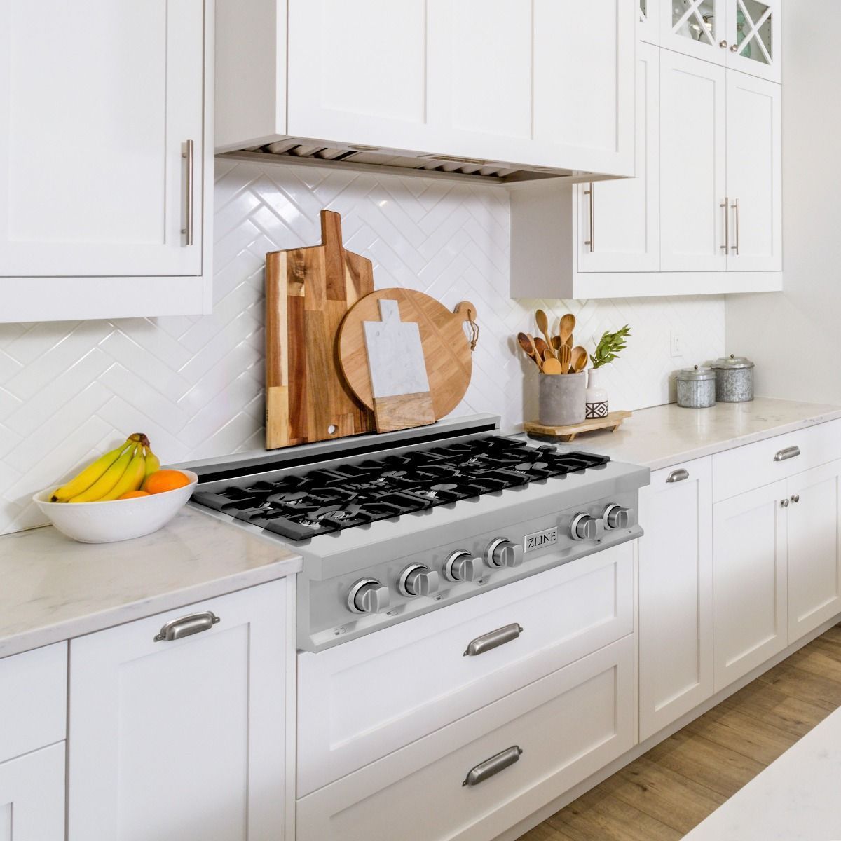 Stainless steel gas rangetop installed in a kitchen with cabinet surrounds