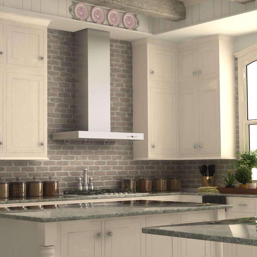 Stainless steel wall-mounted range hood with chimney above a gas cooktop