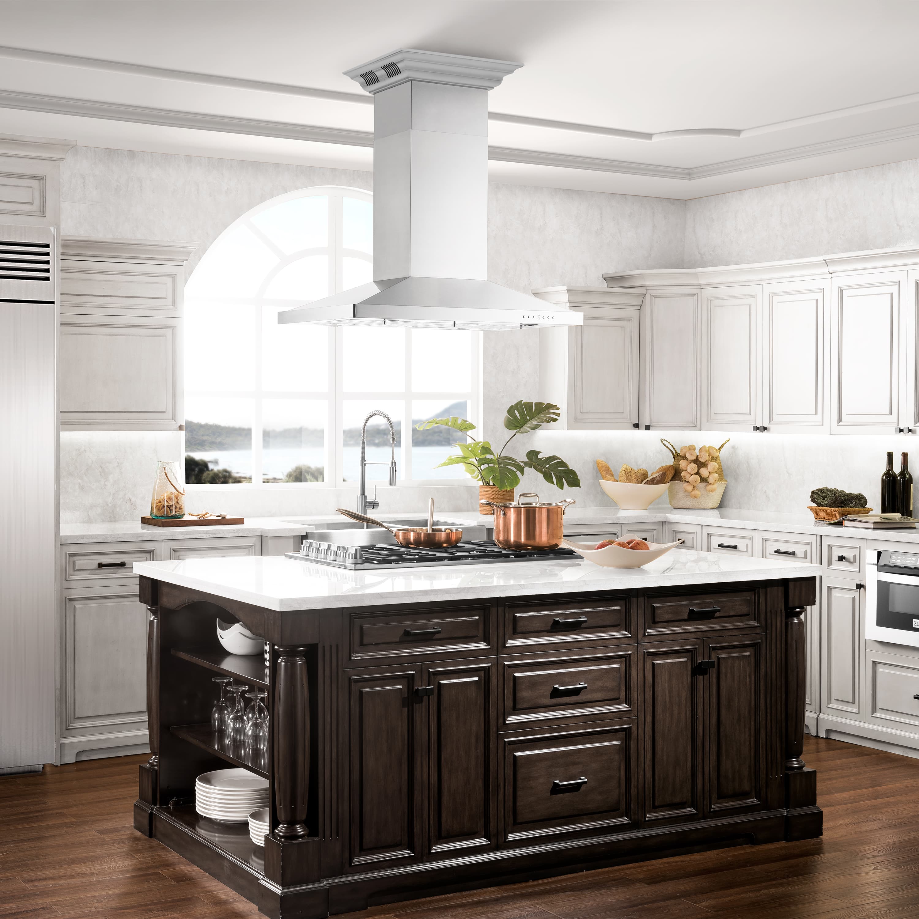 Stainless steel island range hood above cooktop with chimney vent