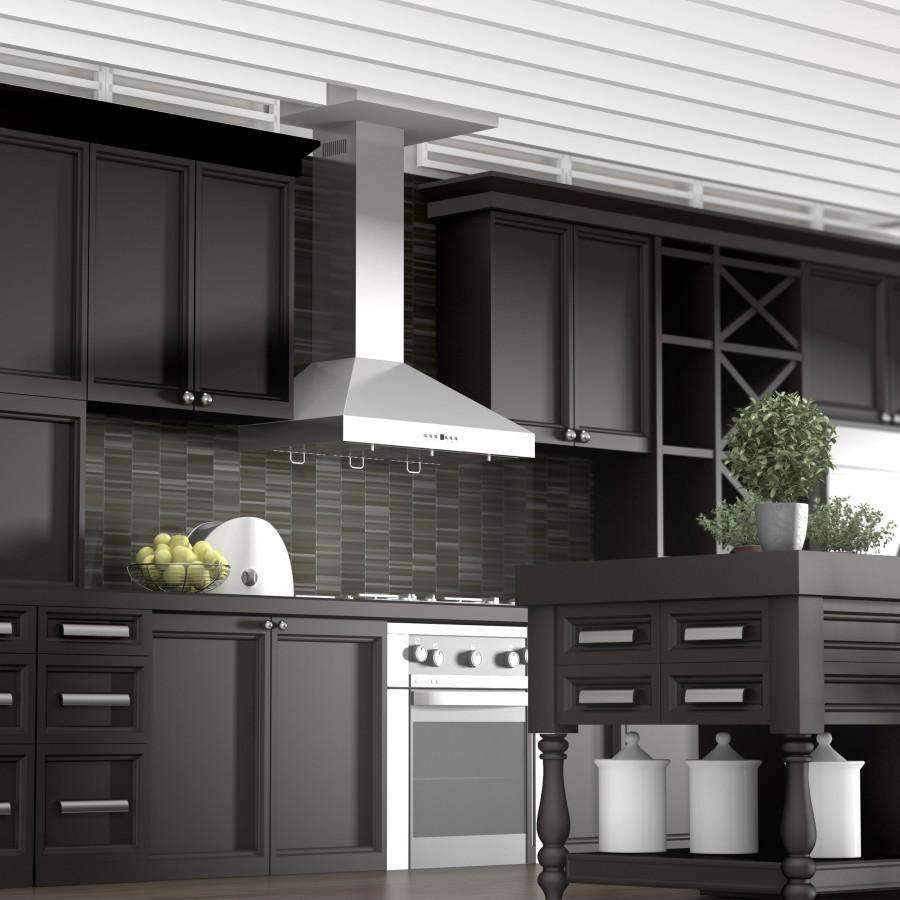 Convertible stainless steel range hood mounted over the stove in a dark kitchen