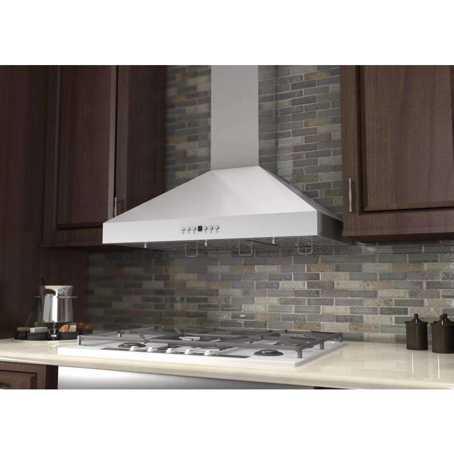 Stainless steel range hood above a gas cooktop with vent baffle and filter grates