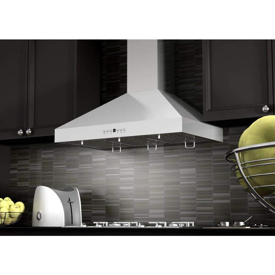 Stainless steel range hood over stovetop with vent grate and control buttons