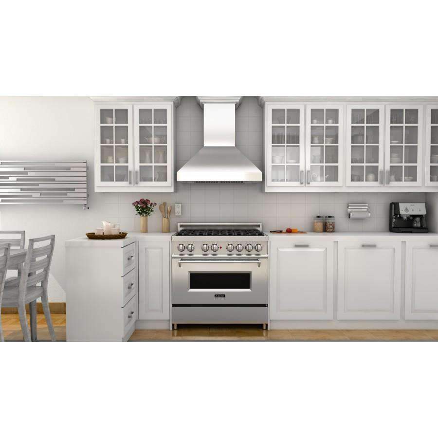 Stainless steel wall mount range hood above gas range, centered in a light kitchen
