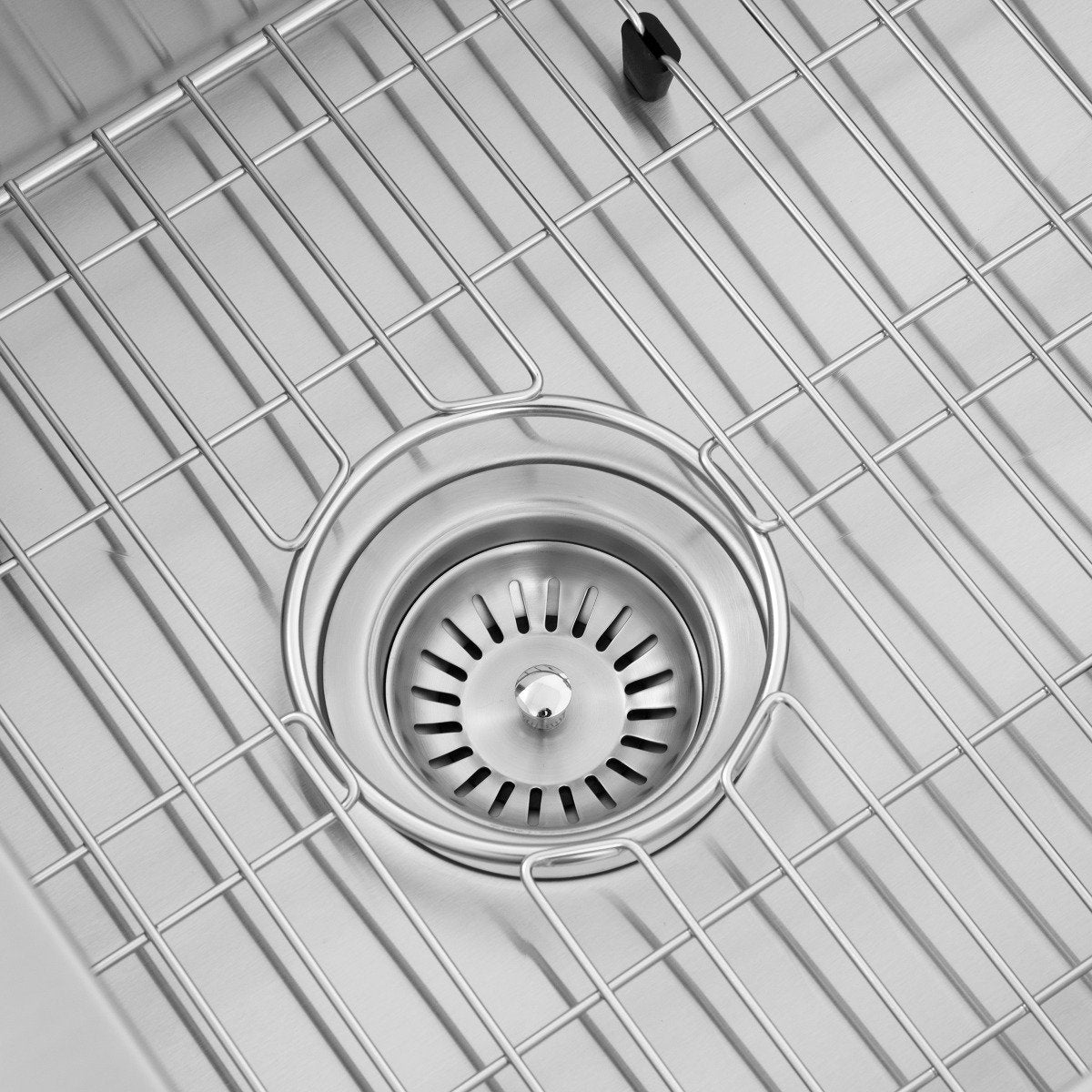 Close-up of sink drain strainer centered in a stainless bottom grid