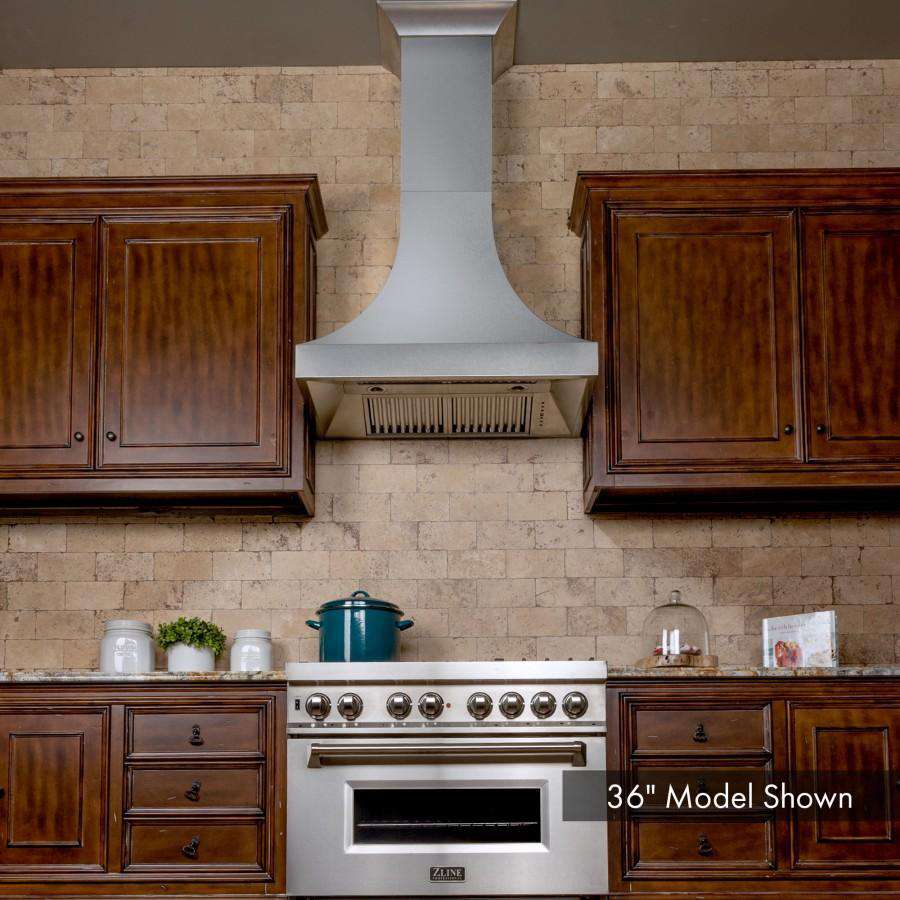 Stainless steel wall range hood chimney centered above kitchen cooktop
