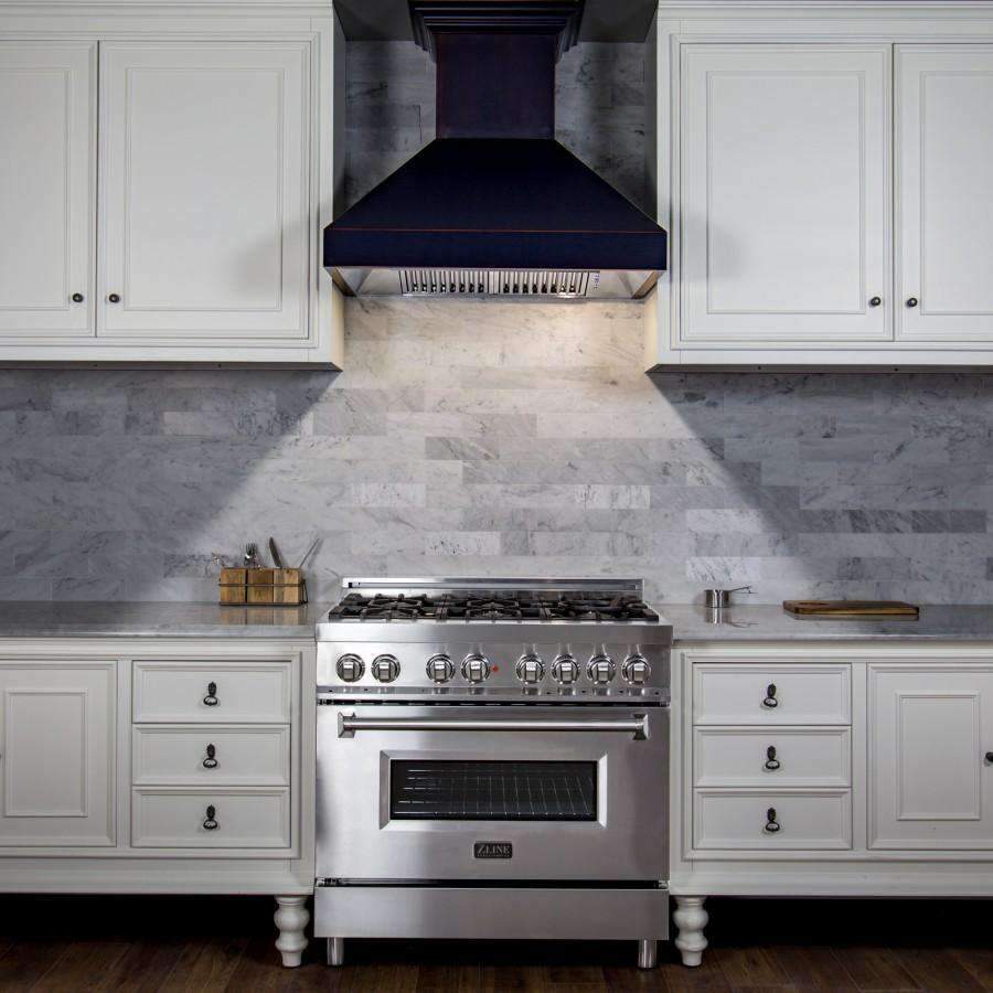 Matte black wall range hood with crown-style trim, centered above gas range