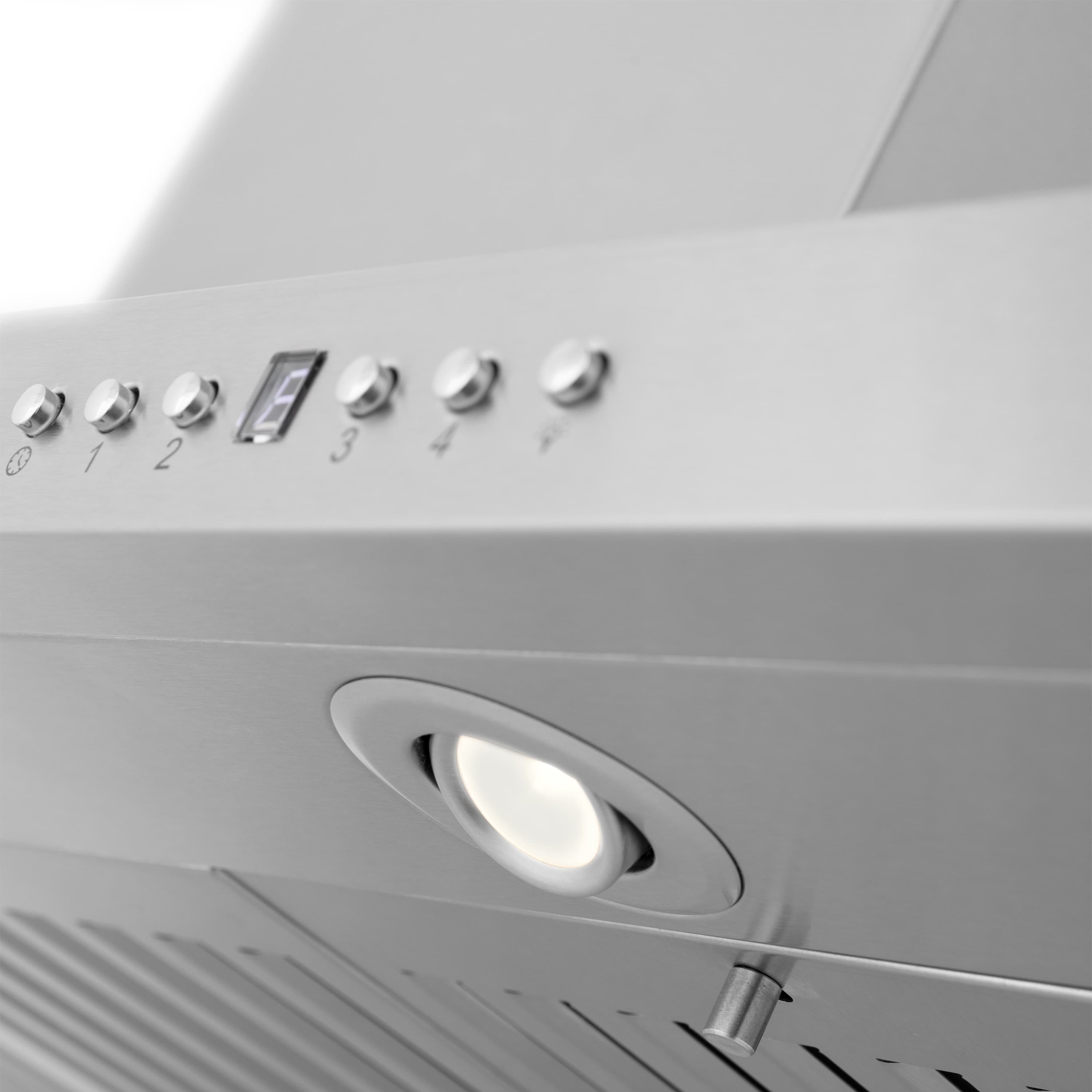Stainless steel range hood side controls with knobs and recessed task light below