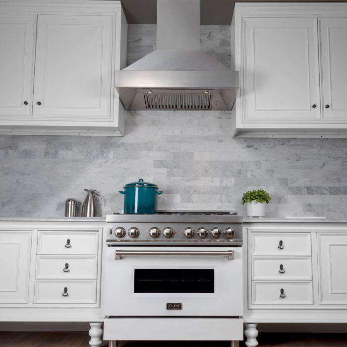 Satin stainless steel wall-mount range hood with vent grille over cooktop