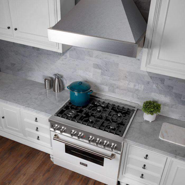 Satin stainless steel wall-mount range hood chimney with vented baffle over cooktop