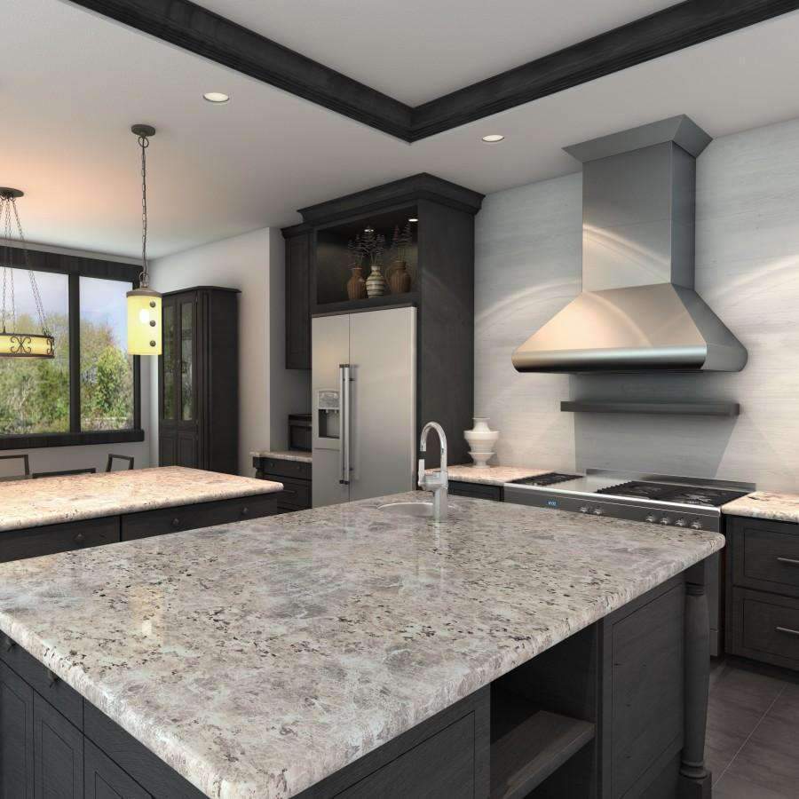 Wall-mounted stainless steel range hood above a kitchen cooktop
