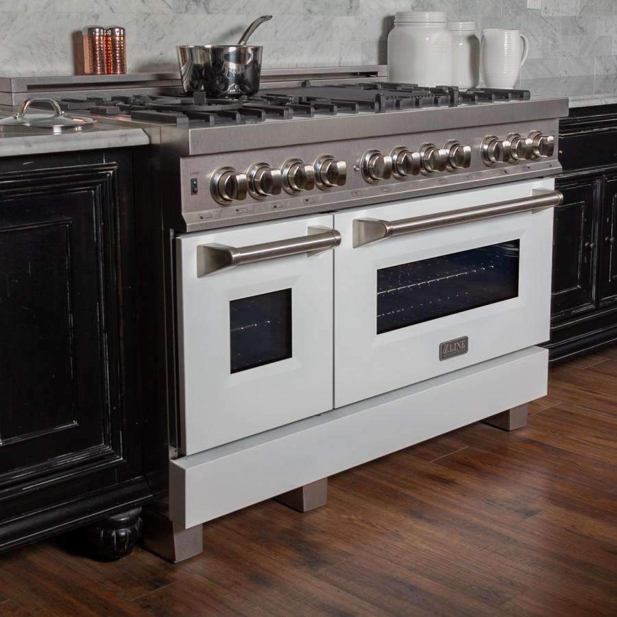Stainless steel dual fuel range front with control knobs, oven windows, and white doors