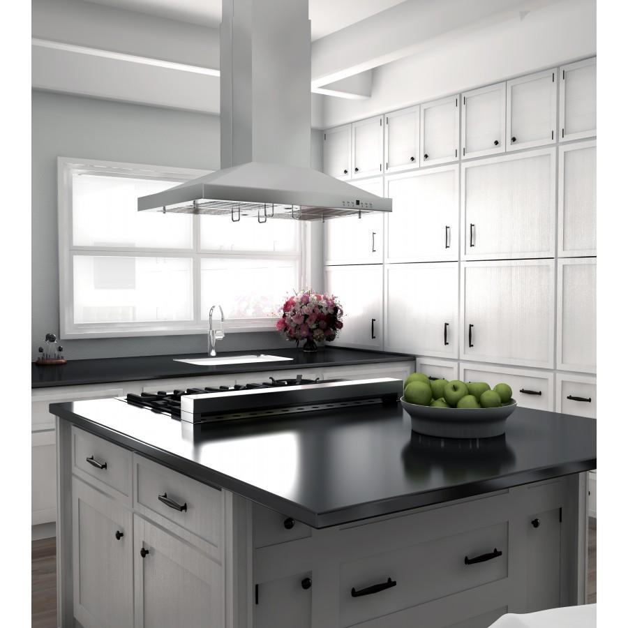 Stainless steel island range hood above a black cooktop and white cabinetry